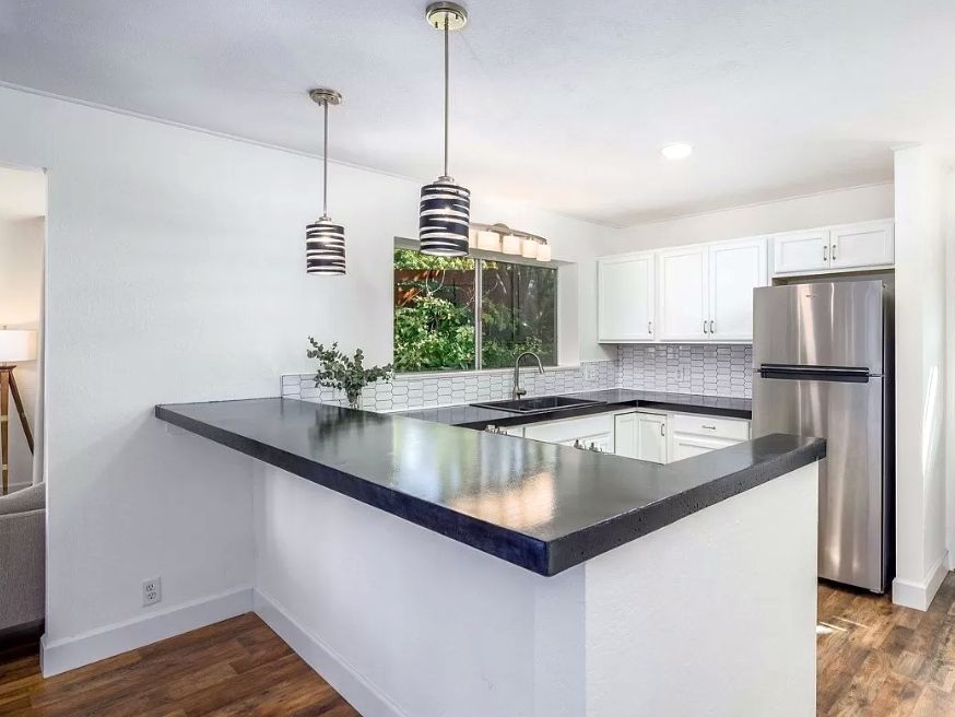 kitchen with white cabinets and black concrete countertops
